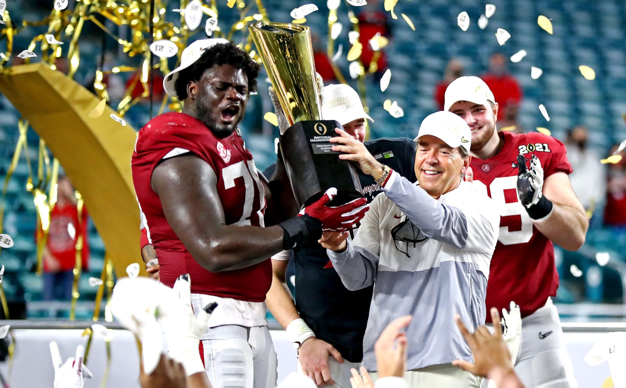 Nick Saban hoists the College Football Playoff trophy after winning the 2020 national championship in Miami against Ohio State.
